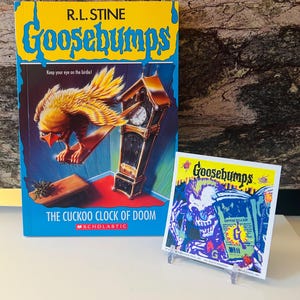 May include: A hardcover book titled "Goosebumps: The Cuckoo Clock of Doom" by R.L. Stine, featuring a bird and clock illustration. A smaller Goosebumps card is displayed next to the book.