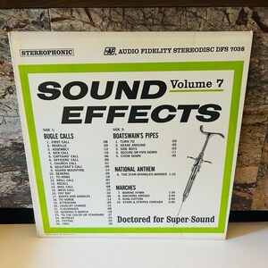 May include: A vintage vinyl record cover with a green and white design. The cover features the title "Sound Effects Volume 7" and lists various sound effects, including bugle calls, boatswain's pipes, national anthem, and marches. The record is by Audio Fidelity and is stereo.
