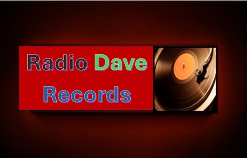 May include: The image features the text "Radio Dave Records" in black, green, and blue lettering on a red background. To the right, a close-up of a vinyl record on a turntable is visible.
