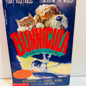 May include: A vintage copy of "Bunnicula: A Rabbit-Tale of Mystery" by Deborah and James Howe. The cover features a cat, dog, and a rabbit with red eyes. The title is in large red letters, with the tagline "Today Vegetables... Tomorrow the World!"