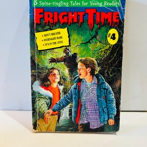 May include: A vintage paperback book titled "FRIGHT TIME #4" with a green and red cover. The cover art depicts two children looking up in fear at a zombie. The book includes the stories "DON'T BREATHE", "OVERNIGHT-MARE", and "IT'S IN THE ATTIC".