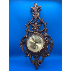 Vintage MCM Syroco Regency Gold 8 day wallclock with key 22.5 in L x 10in W
