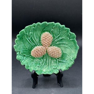 May include: A trio of ceramic mugs with a speckled, matte finish in cream, light grey, and dark grey. Each mug features a simple, minimalist design and a rounded handle.