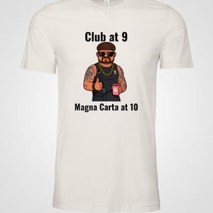 May include: Off-white t-shirt featuring a cartoon illustration of a man with tattoos, sunglasses, and a gold chain. The text "Club at 9" and "Magna Carta at 10" are printed above and below the illustration.