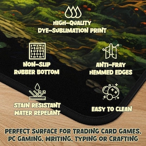 May include: A black mousepad with a detailed landscape design. Features include a non-slip rubber bottom, stain resistance, and easy-to-clean surface. The text on the pad reads "HIGH-QUALITY DYE-SUBLIMATION PRINT", "NON-SLIP RUBBER BOTTOM", "ANTI-FRAY HEMMED EDGES", "STAIN RESISTANT WATER REPELANT", and "EASY TO CLEAN".