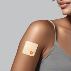 May include: A beige square patch with an orange circle logo is applied to a person's upper arm.