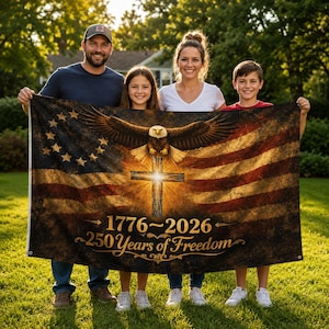 May include: A rectangular flag featuring a distressed American flag design with a central bald eagle perched above a glowing wooden cross. The text 1776-2026 and 250 Years of Freedom is printed in gold script at the bottom with metal grommets.