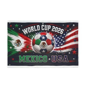 May include: A rectangular flag featuring the text WORLD CUP 2026 and MEXICO USA. The design includes a central soccer ball with red, white, and green panels, flanked by brushstroke patterns of the Mexican and American flags with white stars.