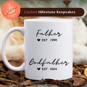 Peut inclure: Mug en céramique blanche avec du texte noir qui dit "Father Est. 1990" et "Godfather Est. 2024".