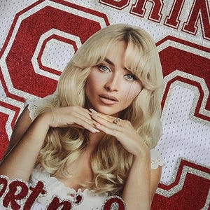 Puede incluir: Camiseta de malla blanca con letras rojas brillantes que dicen "SABRINA" y "Get n' Sweet". Una foto de una mujer con cabello rubio est&aacute; en el centro. El n&uacute;mero 63 tambi&eacute;n est&aacute; en brillo rojo.