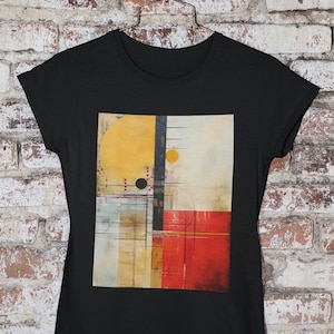 May include: Black t-shirt with a graphic print of an abstract design featuring geometric shapes in yellow, red, and brown.