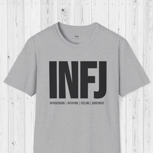 May include: Gray t-shirt with the letters "INFJ" printed in black. Below the letters is the text "Introversion | Intuition | Feeling | Judgement".