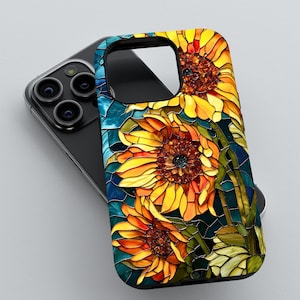 May include: A black smartphone case featuring a stained-glass design of sunflowers in shades of yellow, orange, and brown. The case has a dark blue background and a glossy finish. The phone case is shown on top of a black smartphone.