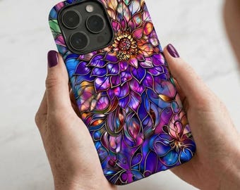 May include: A smartphone case featuring a vibrant, stained-glass style floral pattern. The design displays layered petals in shades of deep purple, magenta, blue, and orange, outlined with dark lines. The case includes a cutout for a triple-lens camera.
