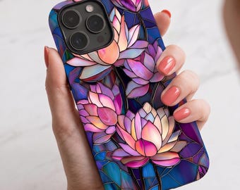 May include: A smartphone case featuring a stained glass pattern of pink and purple lotus flowers against a deep blue background. The design includes dark outlines separating the floral shapes, creating a vibrant, multi-coloured mosaic effect.