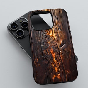 May include: A black phone case with a wood grain design. The case has a dark brown and orange wood grain pattern.