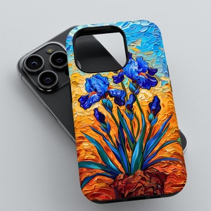 May include: A phone case featuring a vibrant floral design. The case showcases a stylized painting of blue irises against a warm orange and yellow background, with blue sky accents. The case is black.
