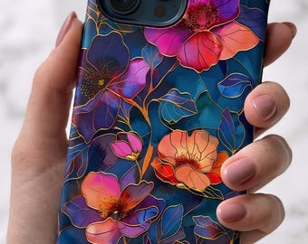 May include: A smartphone case featuring a dark blue background with a vibrant floral pattern. The design includes stylized flowers in shades of pink, orange, and purple, outlined with thin gold lines that create a stained-glass effect.