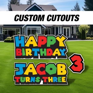 May include: Customizable yard signs with a "Happy Birthday" message in colorful block letters, a name "Jacob" and the words "Turns Three" in colorful block letters, and a large number "3" in red.