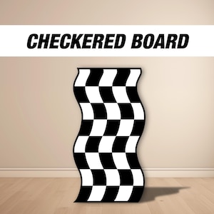 May include: A black and white checkered board, resembling a finish line flag, is standing upright on a wooden floor.