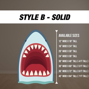 May include: A shark-shaped wall art cutout with an open mouth, featuring red teeth and a light blue exterior. The text "STYLE B - SOLID" is at the top. Available sizes range from 12" x 18" to 45" x 84".