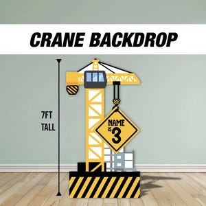 May include: A yellow and black construction crane backdrop for a birthday party. The crane is 7 feet tall and has a sign that says "Name is 3".