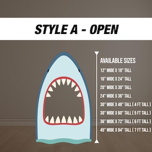 May include: A shark-shaped cutout with an open mouth, featuring a light blue body, white teeth, and a red-lined mouth. Text at the top reads "STYLE A - OPEN." Available sizes range from 12" x 18" to 45" x 84".