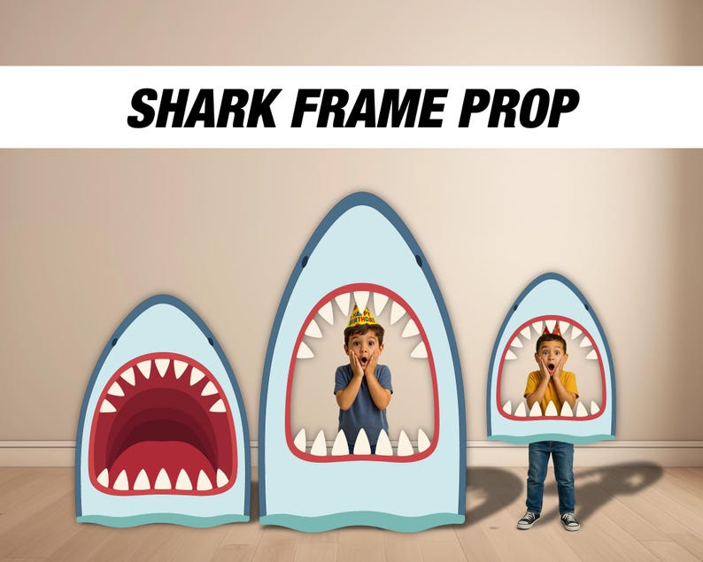May include: Three shark-shaped photo props with open mouths, in varying sizes. The props are light blue with red and white details. The text "SHARK FRAME PROP" is displayed above the props. Two children are inside the props.