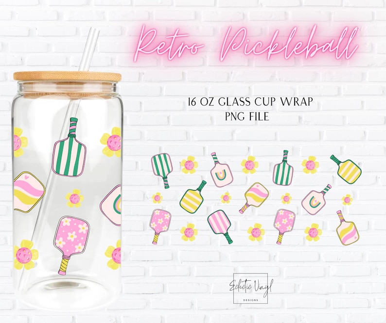May include: A clear 473 ml glass cup with a bamboo lid and straw, decorated with a pickleball design. The design includes pickleball paddles and flowers in pink, yellow, and green. The text "Retro Pickleball" is displayed in pink neon.