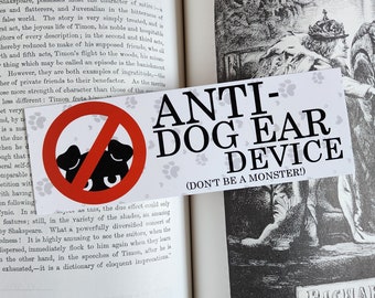 May include: A white sticker with a red circle and a black dog silhouette inside. The circle has a diagonal red line through it. The sticker says "ANTI-DOG EAR DEVICE (DON'T BE A MONSTER!)"