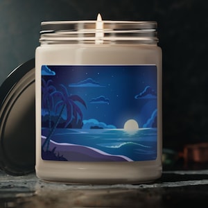 May include: A white candle jar with a blue and white illustration of a beach scene at night with palm trees, a full moon, and stars. The candle jar has a black lid.