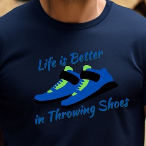 May include: A navy blue t-shirt with the text "Life is Better in Throwing Shoes" and a pair of blue and green throwing shoes.