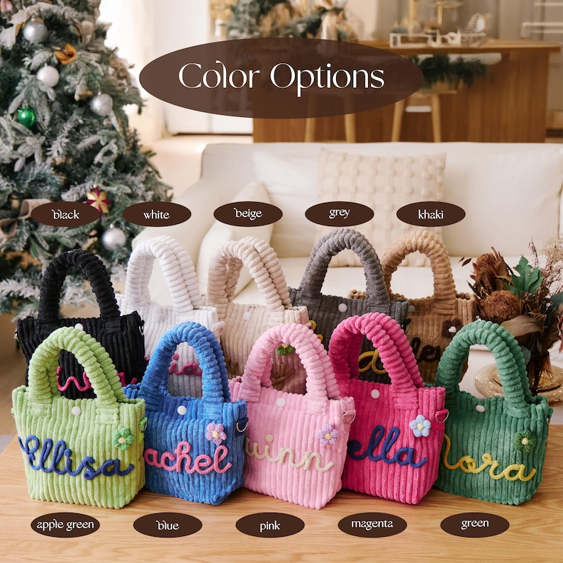 May include: A collection of corduroy tote bags in various colors, including black, white, and pink. Each bag features a handle and a name embroidered on the front. The color options are displayed above the bags.