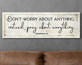 May include: A white canvas sign with a distressed texture and black text that reads "DON'T WORRY ABOUT ANYTHING; instead, pray about everything. Philippians 4:6".