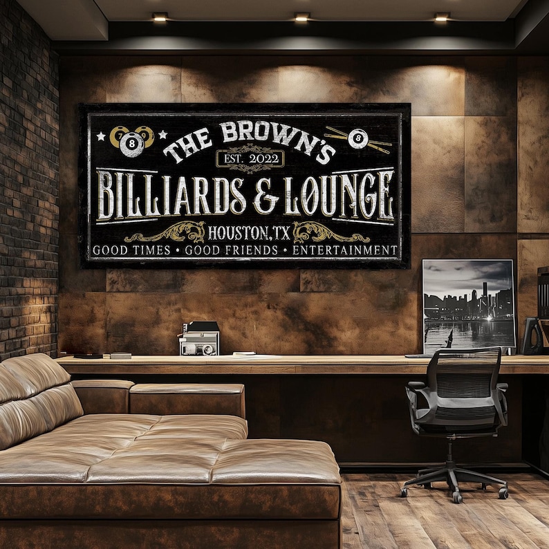 May include: A black and white sign with the text "The Brown's Billiards & Lounge" in a vintage style font. The sign also includes the text "Est. 2022", "Houston, TX", and "Good Times Good Friends Entertainment".