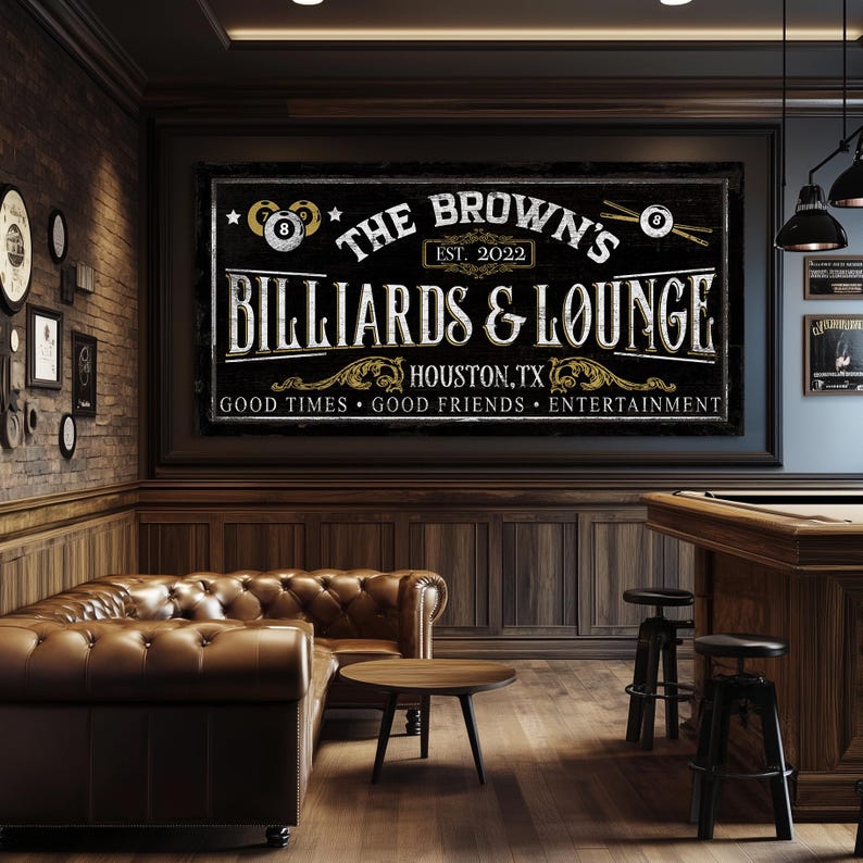 May include: A black and gold sign with the text "The Brown's Billiards & Lounge" with the words "EST. 2022" and "Houston, TX" below. The sign also has the text "Good Times Good Friends Entertainment" at the bottom.