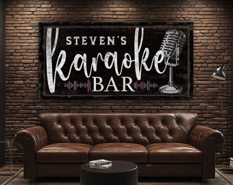 May include: A black and white sign with the text "Steven's Karaoke Bar" and a microphone graphic. The sign is hanging on a brick wall above a brown leather couch.