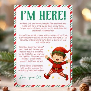 May include: A festive Christmas card with a red and green border, featuring the text "I'M HERE!" and a cheerful elf illustration. The card includes a message from the elf, inviting the recipient to have fun and be polite.