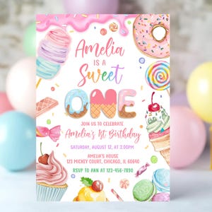 May include: A colorful invitation for Amelia's 1st birthday, featuring a sweet theme. The design includes illustrations of ice cream, donuts, and candy. The text reads "Amelia is a Sweet One" with event details: date, time, and location.