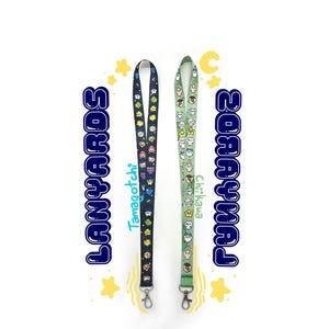 May include: Two lanyards with cartoon character designs. One is black with colorful characters and the text "Tamagotchi". The other is light green with cartoon characters and the text "Chikawa". Both have silver-colored clasps and the word "Lanyards" in blue.