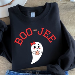 May include: Black sweatshirt with a red "BOO-JEE" graphic and a white ghost holding a small orange pumpkin. The ghost has a red bow and a smiling face.