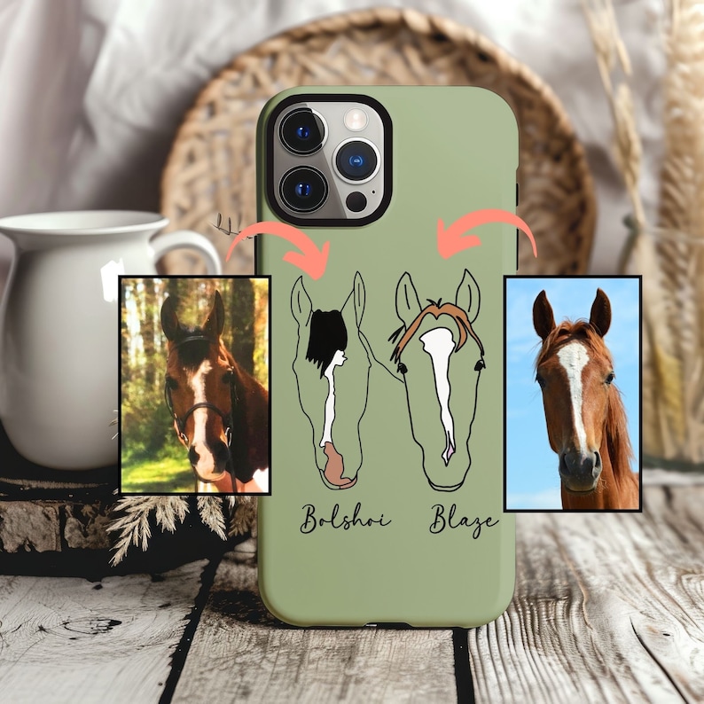 May include: A green phone case with a white outline of two horses' heads and the names "Bolshoi" and "Blaze" printed on the bottom. The case has a camera cutout and a white background.