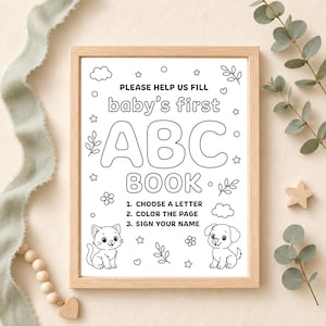 Framed printable baby shower ABC book sign with simple instructions to choose a letter, color the page, and sign your name, decorated with cute animals.