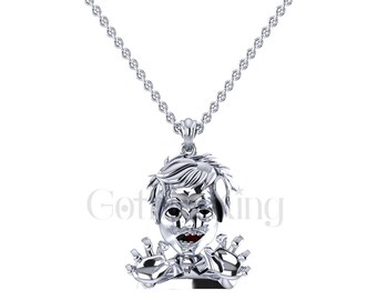 May include: Silver necklace with a pendant of a cartoon boy with a toothy grin and outstretched arms.