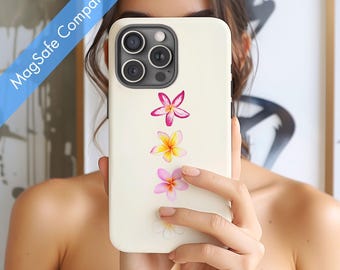 May include: Off-white phone case with a floral design featuring pink and yellow flowers. The case has a MagSafe Compatible label in the upper left corner. The phone case has a camera module with three lenses.