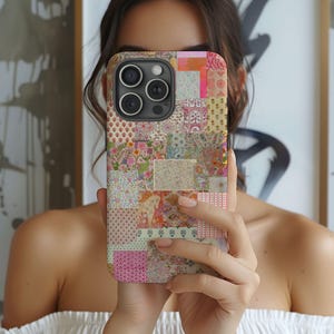 May include: A colorful phone case with a patchwork design featuring various floral and geometric patterns. The case is made up of different colored squares and rectangles, creating a vibrant and eclectic look.