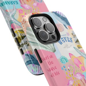 Op de afbeelding: Een roze en blauwe telefoonhoes met een kleurrijk collage-ontwerp. Het ontwerp bevat een schelp, een zeester, een walvis en de tekst "Surf on the wave of life" en "Comes in Waves".