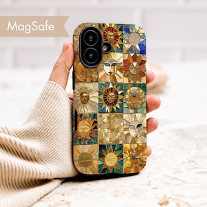 May include: A decorative phone case featuring a mosaic design with sun and face motifs in gold, blue, and brown tones. The case has a MagSafe label in the upper left corner. The phone case is held in a person's hand.