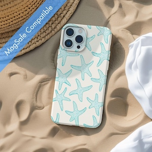 May include: A white phone case with a blue starfish pattern. The case is compatible with MagSafe.
