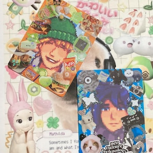 May include: Two decorative cards with pixelated portraits, adorned with stickers of food, animals, and accessories. One card is orange and green, the other blue. The background features a panda and text in Japanese.